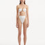 Front view of the Clyde White Bikini Bottom highlighting the high-waist design and gold sculpted accessories.