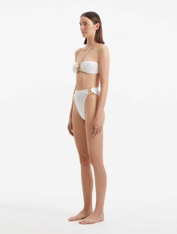 Side view emphasizing the high-waist design and elegant silhouette of the Clyde White Bikini Bottom.