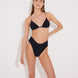 Front View: Model in Como Black Bikini Bottom - MOEVA Luxury Swimwear, High-Waist, High-Leg Silhouette, Stitching Details, Full Bottom Coverage, MOEVA Luxury Swimwear  