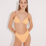 "Model wearing the Como Orange High-Waisted Bikini Bottom from the front, highlighting its high-leg cut, topstitching details, and full bottom coverage."