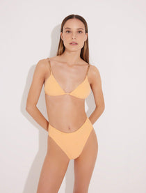 Model wearing the Como Orange Triangle Bikini Set from the front, showcasing the geometric gold chain straps and classic triangle design."