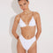 Front View: Model in Como White Bikini Bottom - MOEVA Luxury Swimwear, High-Waist, High-Leg Silhouette, Stitching Details, Full Bottom Coverage, MOEVA Luxury Swimwear  