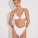 Front View: Model in Como White Bikini Bottom - MOEVA Luxury Swimwear, High-Waist, High-Leg Silhouette, Stitching Details, Full Bottom Coverage, MOEVA Luxury Swimwear  
