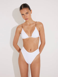 Front View: Model in Como White Bikini Bottom - MOEVA Luxury Swimwear, High-Waist, High-Leg Silhouette, Stitching Details, Full Bottom Coverage, MOEVA Luxury Swimwear  