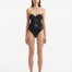 Front view of the Coral Black Swimsuit showcasing the balconette style and gold sculpted accessory detail.