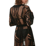 " Model wearing the Daniela Black Kaftan from the back, highlighting the sheer fabric and modern geometric prints."