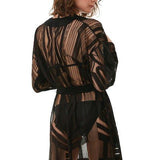 " Model wearing the Daniela Black Kaftan from the back, highlighting the sheer fabric and modern geometric prints."