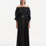 "Model showcasing the Dante Black Dress from the front, highlighting the ruched neckline and off-the-shoulder design."