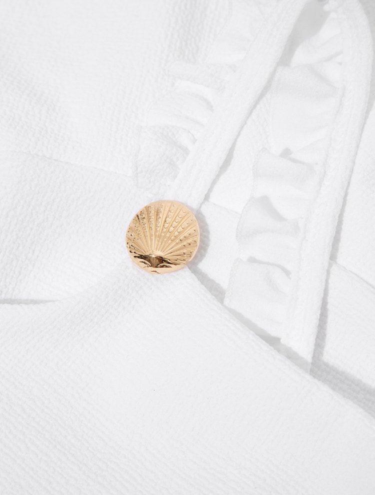 "Close-up of the ruffle details on the Dassy white kids bikini set’s top, highlighting the playful and stylish design."