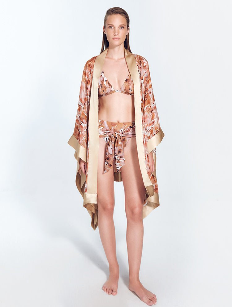 Front View: Model in Delfina Floral Abstract/Nude Kaftan - MOEVA Luxury Swimwear, Long Sleeved, Mid-Thigh Length, Short Silk Kaftan, MOEVA Luxury Swimwear