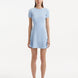 "Model wearing the Derin Baby Blue Dress from the front, showcasing the knee-length cut and shell-shaped gold buttons."
