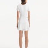 "Back view of the Derin White Dress, featuring the back zip and smooth lines of the design."