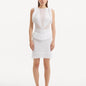 "Model displaying the Diani White Dress from the front, showcasing its knee-length design and pristine white mesh knit fabric."