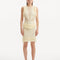 "Model wearing the Diani Yellow Dress from the back, highlighting the low back design with gleaming golden clasps and the delicate mesh knit fabric."