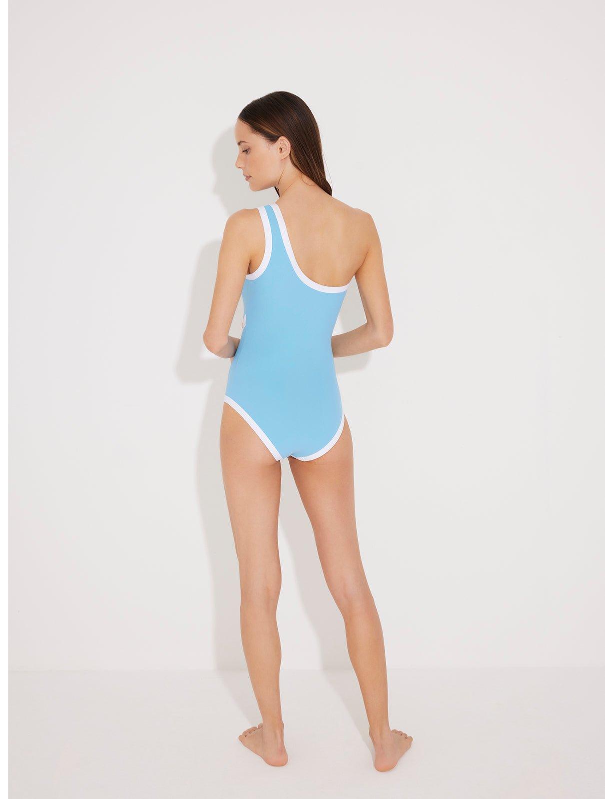 Back View: Model in Dido Blue/White Swimsuit  - One Shoulder, Removable Sleeves, Slash Cutout, Duo Colored, Gold Button Detailing, One Piece Swimsuit, MOEVA Luxury Swimwear 