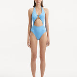Model wearing the Dwyn Baby Blue Swimsuit, highlighting the tie-neck design and gold sculpted accessory.