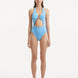 Model wearing the Dwyn Baby Blue Swimsuit, highlighting the tie-neck design and gold sculpted accessory.