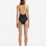 Back view of the Dwyn Black Swimsuit, showcasing the high waist and moderate bottom coverage.