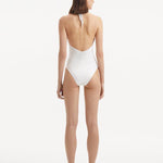  Back view of the Dwyn White Swimsuit, showcasing the high waist and moderate bottom coverage.