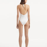  Back view of the Dwyn White Swimsuit, showcasing the high waist and moderate bottom coverage.