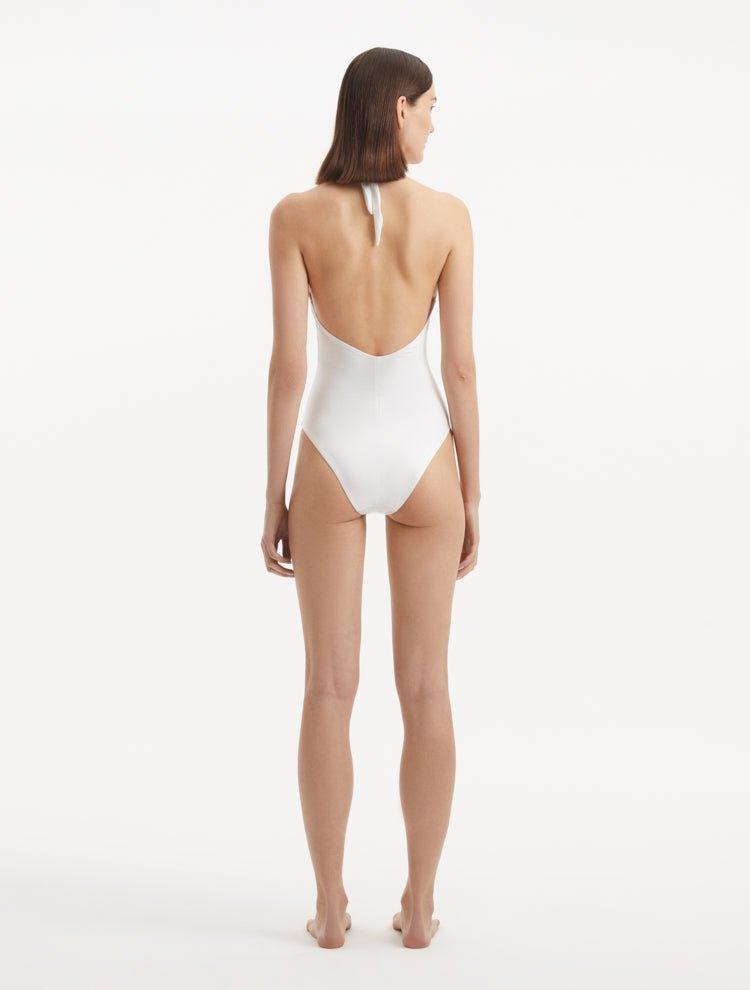  Back view of the Dwyn White Swimsuit, showcasing the high waist and moderate bottom coverage.