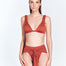 "Red Ochre Dylan Bikini Bottom on a model from the front, showing the high-rise waist and adjustable tie-front detail."