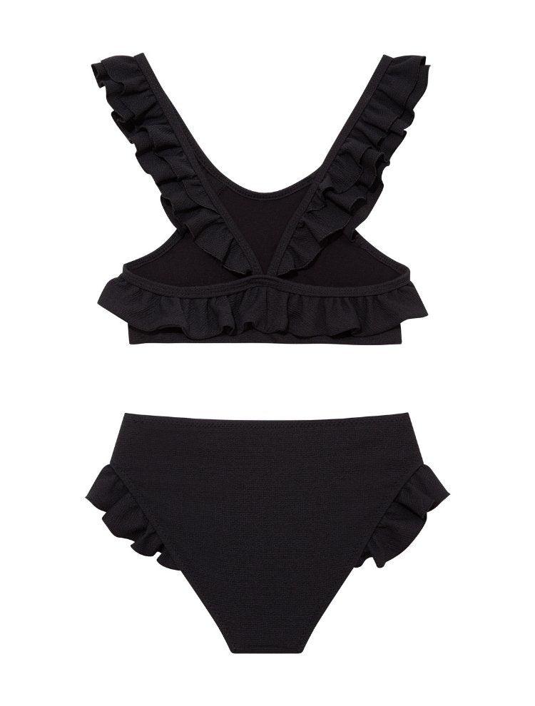 "Back view of the Effy black kids bikini set, highlighting the secure fit of the full-coverage bottoms and classic design."