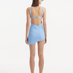 Back view of the Ephram baby blue skirt, demonstrating the high-waist fit and the elegant fall of the asymmetric cut. The wavy edges and texture details contribute to the skirt's sophisticated look.