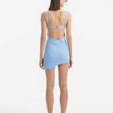 Back view of the Ephram baby blue skirt, demonstrating the high-waist fit and the elegant fall of the asymmetric cut. The wavy edges and texture details contribute to the skirt's sophisticated look.