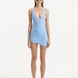 Model showcasing the Ephram baby blue skirt from the front, highlighting its high-waist design and bold asymmetric cut. The intricate wavy texture adds depth and visual interest to the soft baby blue hue.