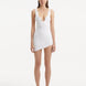"Model wearing the Ephram white high-waist asymmetric skirt from the front, highlighting the flattering high-waist design and intricate wavy texture. The asymmetric cut and flowing silhouette emphasize modern elegance."