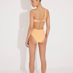 "Model wearing the Etta Orange/Nude One-Shoulder Bikini Top from the back, highlighting the single adjustable strap and mesh details. "