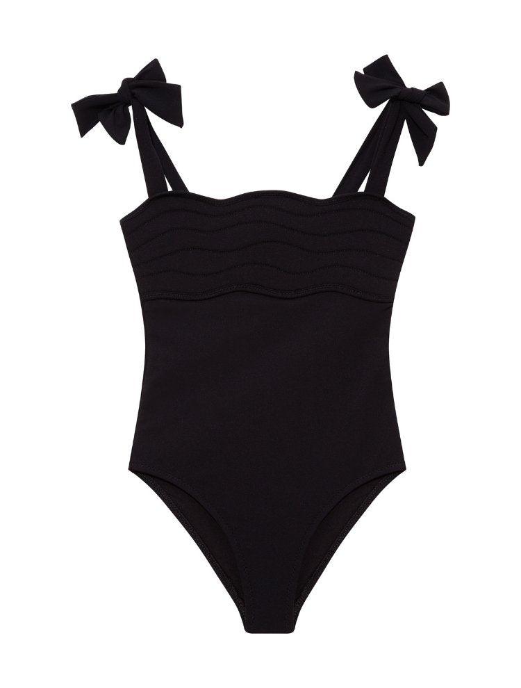 Model wearing the Everlee Black Swimsuit, showcasing the self-tie straps and ruffle details.