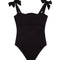 Model wearing the Everlee Black Swimsuit, showcasing the self-tie straps and ruffle details.