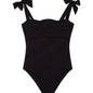 Model wearing the Everlee Black Swimsuit, showcasing the self-tie straps and ruffle details.