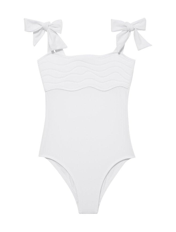 Model wearing the Everlee White Swimsuit, highlighting the self-tie straps and ruffle details.