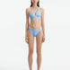 Model wearing the Eyre Baby Blue Bikini Bottom, highlighting the mid-rise design and shell-shaped gold button details.