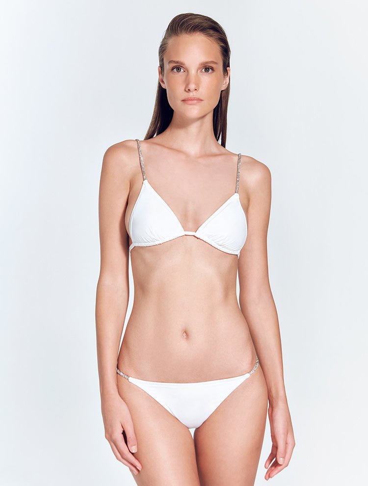 Front View: Model in Faith White Bikini Top - MOEVA Luxury Swimwear, Crystal Embellished Straps, Triangle Top, Removable Paddings,  Fully Lined, Chic and Accessorised, Rhinestone Fabric MOEVA Luxury Swimwear