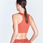 "Fanny Red Ochre Sports Bra back view showcasing the geometric design and smooth satin matte fabric. 