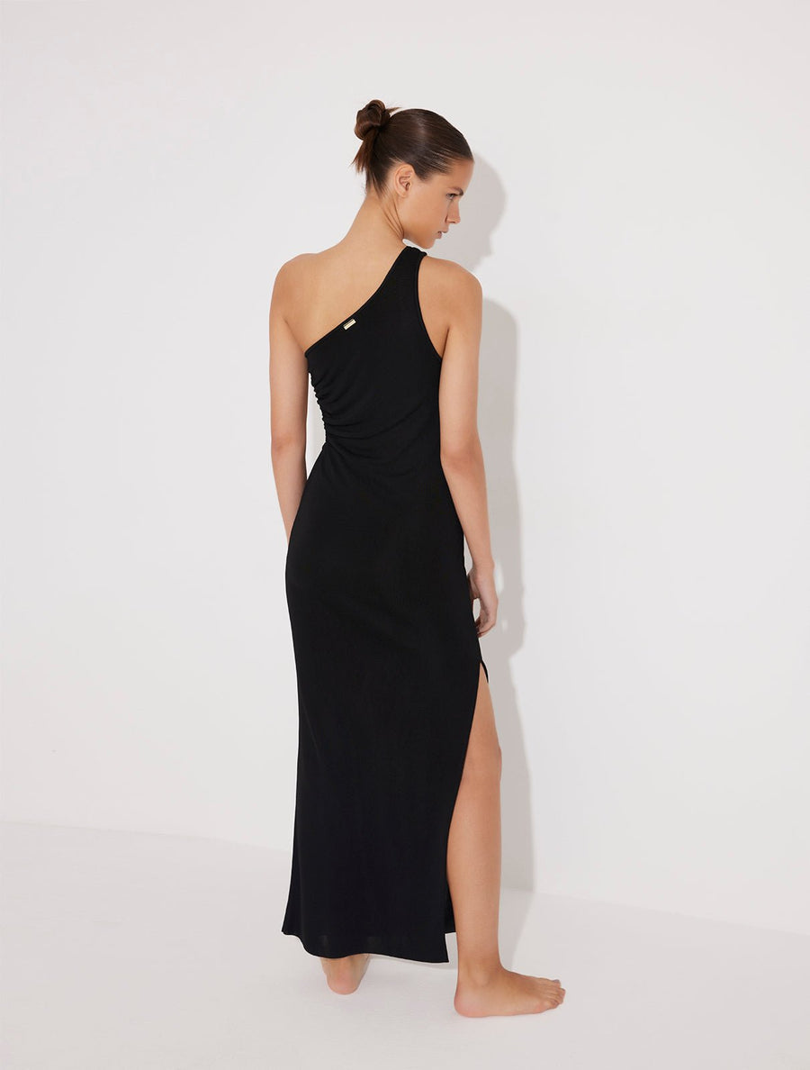 Back View: Model in Fewa Black Dress - MOEVA Luxury Swimwear, Knitted, Ankle Length, Ruched Cutout, Close Fit, MOEVA Luxury Swimwear