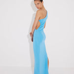 "Back view of the Fewa Blue One-Shoulder Knitted Dress revealing the elegant cut and high-shine viscose material, perfect for formal occasions and summer festivities."