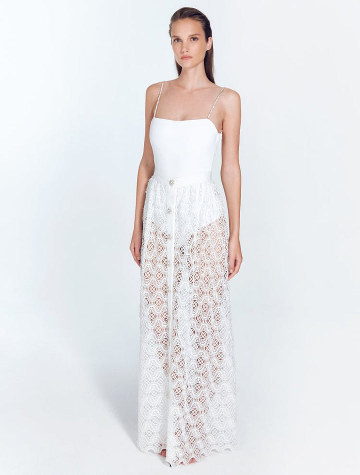 Front View: Model in Flavy White Skirt - Satin Matte Contrast, Low Rise, Moderate Coverage, Maxi Skirt, Unlined, Chic and Accessorised, Rhinestone Fabric, MOEVA Luxury Swimwear