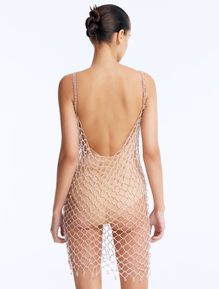 Back View: Flora Silver Swimsuit on Model - Low Back, Clear Glass Beaded Mini Macrame Dress, Nude Swimsuit Inside, Fully Lined, MOEVA Luxury Swimwear