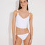 Front View: Model in Franca White Bikini Bottom - MOEVA Luxury Swimwear, Low-Waist, Gold Rectangle Accessory, Moderate Bottom Coverage, MOEVA Luxury Swimwear  