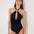 Front View: Model in Giovanna Black Swimsuit - MOEVA Luxury Swimwear, Plunging Halter Neck, Tie Neck, Twist-Front Detail, Gold Sculpted Hoop Accessory, Removable Padding Black Swimsuit,  MOEVA Luxury Swimwear 
