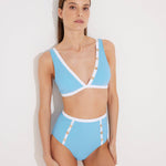 Front View: Model in Greca Blue/White Bikini Bottom - MOEVA Luxury Swimwear, High-Waist, Gold Button Details, Duo Colored, Full Bottom Coverage MOEVA Luxury Swimwear  