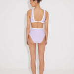 "Back view of the Greca lilac/white high-waisted bikini bottom, showcasing its high-cut design."