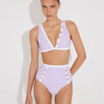 Front View: Model in Greca Lilac/White Bikini Top - MOEVA Luxury Swimwear, V-Neck, Gold Button Details, Duo Colored, Removable Padding, MOEVA Luxury Swimwear 