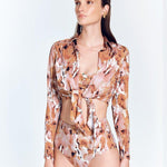 "Front view of a model in the Greta Floral Abstract Shirt, displaying its cropped length and stylish design."