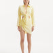 "Model wearing theGreta Yellow Shirt and Maeby Skirt from the front, showcasing its bright yellow hue, front tie detail, and stylish cropped silhouette for a lively, beach-to-city look."